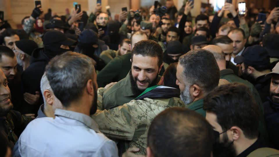 People welcome the leader of the Syrian Islamist Hayat Tahrir al-Sham (HTS) group, Abu Mohammed al-Jolani, before his speech at the Umayyad Mosque on December 8, 2024. - Aref Tammawi/AFP/Getty Images