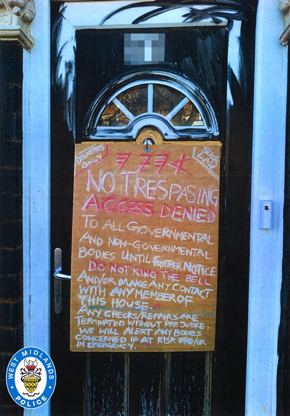 A sign on the front door of the couple's home warns people to stay away (PA)