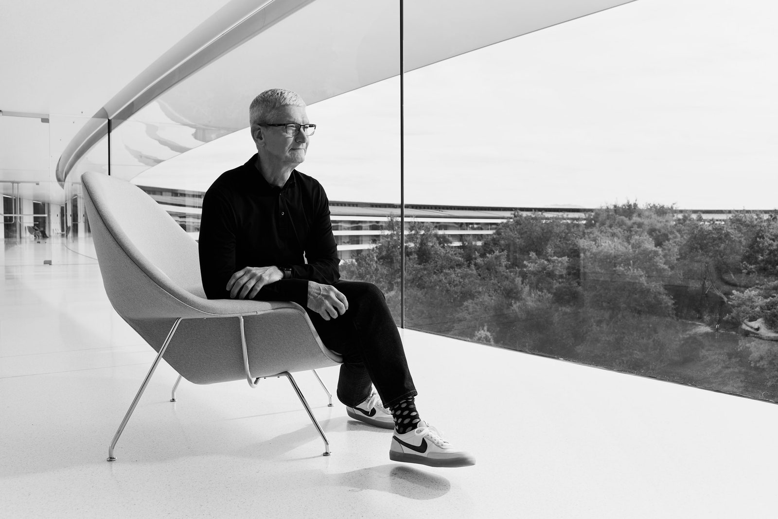 Image may contain Tim Cook Person Sitting Chair Furniture Adult Accessories Glasses Clothing Footwear & Shoes