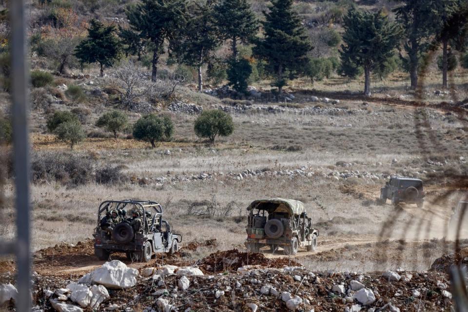 Israeli military vehicles drive after crossing the fence into the buffer zone with Syria, near the Druze village of Majdal Shams on the Israeli-annexed Golan Heights (AFP via Getty Images)