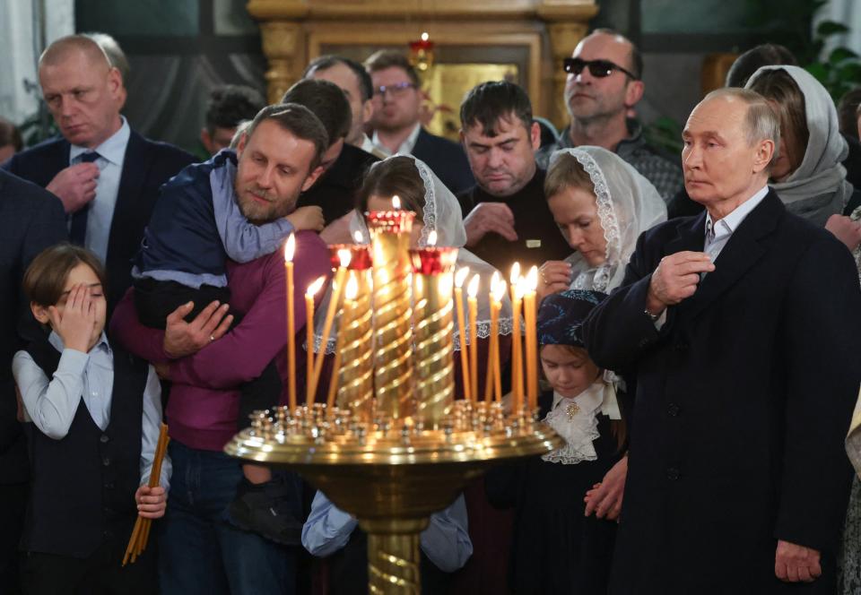 Putin asked the country's highest priest to engrave his own initials on chains for the crosses carried by soldiers. / Getty Images