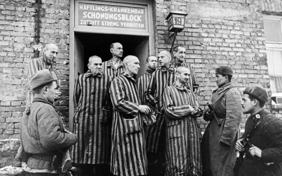 Soviet soldiers of the Red Army of the First Ukrainian Front with liberated prisoners of the Auschwitz concentration camp