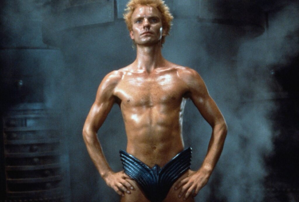 thin man with spiky blond hair, naked except for a futuristic codpiece