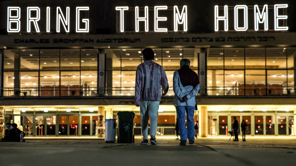 A neon sign referring to the Israeli hostages held in Gaza on December 9, 2023, atop the Charles Bronfman Auditorium in Tel Aviv's HaBima Square. - Ahmad Gharabli/AFP/Getty Images