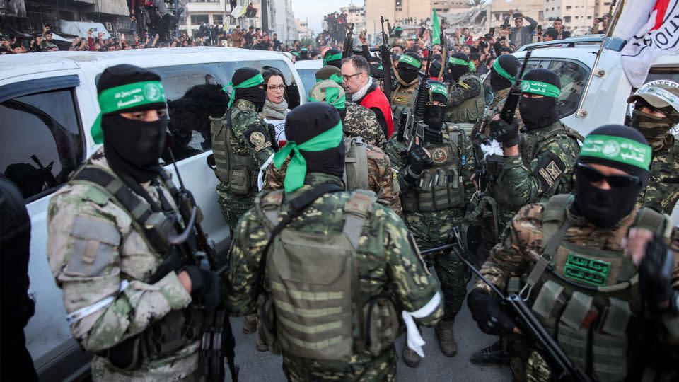 Members of the International Committee of the Red Cross speak with fighters from the Ezzedine al-Qassam Brigades, the armed wing of Hamas, in Saraya Square in western Gaza City on January 19, 2025. - Omar Al-Qattaa/AFP via Getty Images