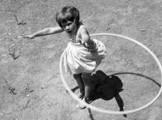 Girl spinning a hula hoop, 1958