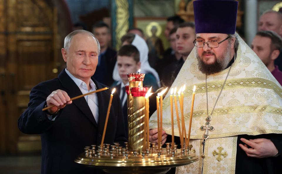 Putin attends the Christmas service at St. George's Church in Moscow. / Getty Images