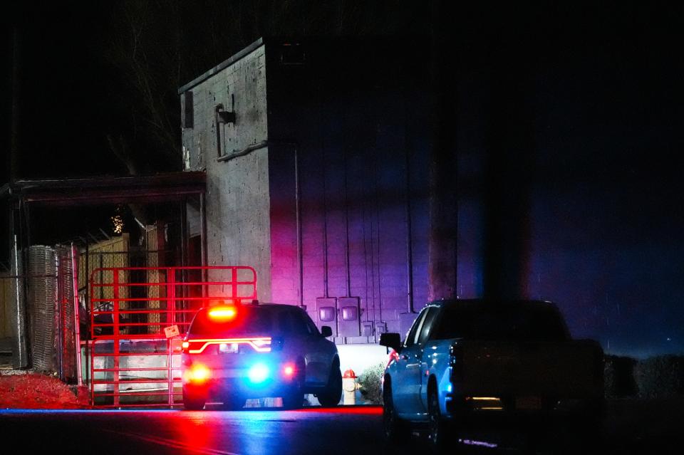 A police vehicle sits outside a New Albany warehouse Friday evening in the 1800 block of East Market, where Indiana State Police are following a tip that a man was suspected in a shooting Friday morning of an Orange County sheriff's deputy at 3 January could be in the area. , 2025.