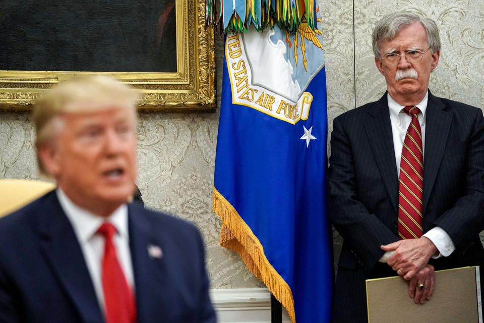 John Bolton listens to Donald Trump. (Chip Somodevilla / Getty Images file)