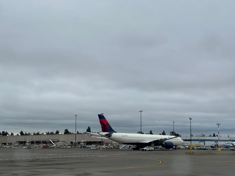 A Delta Air Lines plane under cloudy skies at Seattle-Tacoma International Airport on June 27, 2024.