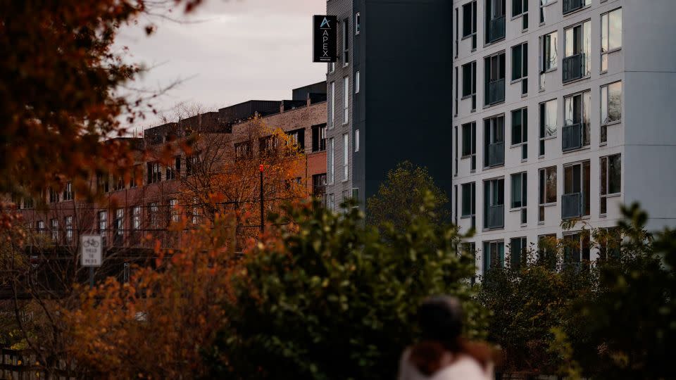 A person cycling from Apex Manayunk, the apartment building where Ellen Greenberg died, in Philadelphia on November 20, 2024. - Hannah Beers for CNN