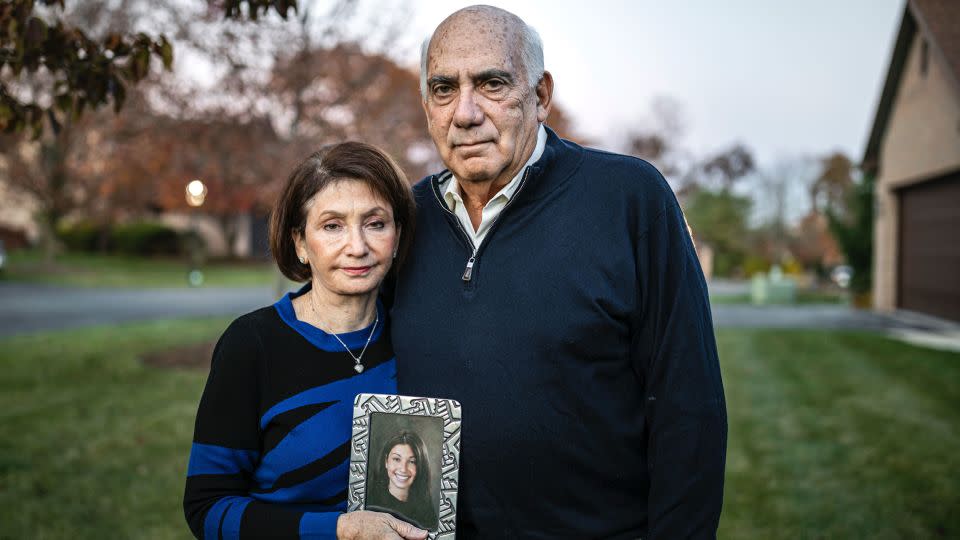 Josh and Sandee Greenberg pose for a portrait with a photo of their daughter Ellen in November 2021. - Dan Gleiter/Pennlive