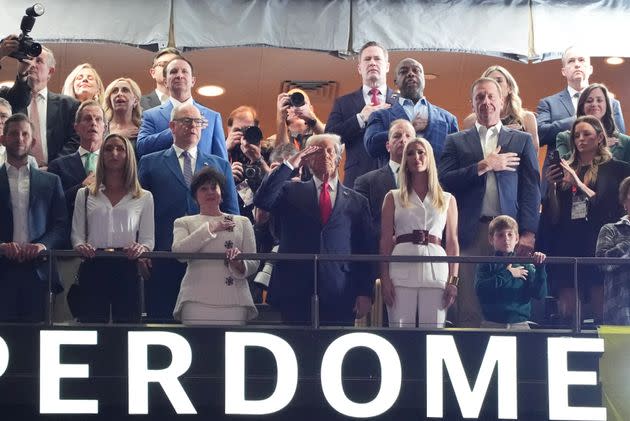 US President Donald Trump stands as the American singer-songwriter Jon Baptiste performs the national anthem prior to Super Bowl Lix between the Kansas City Chiefs and the Philadelphia Eagles in Caesar's Superdome in New Orleans, Louisiana, 9 February 2025. (Photo by Timothy A. Clary / AFP) (Photo by Timothy A. Clary / AFP via Getty Images) 