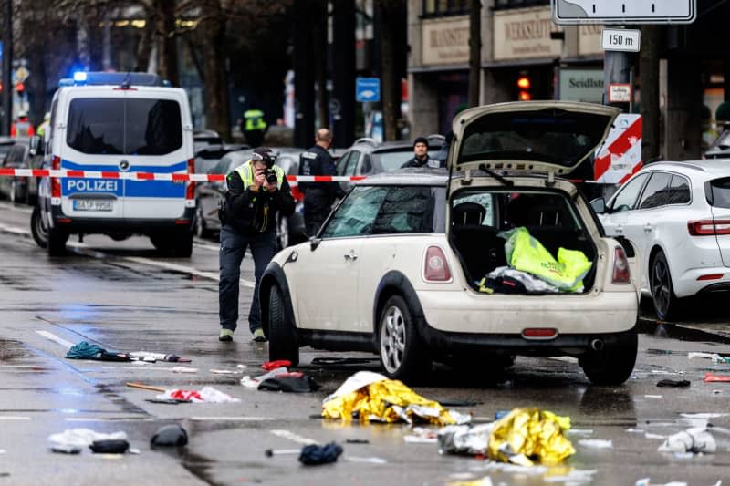 Police officers investigate a car near a crime scene in the city center of Munich, where a vehicle entered a group of people. As the police announced on platform X, several people were injured. "We are currently on site with strong forces," said a police spokesperson. Matthias Balk/DPA