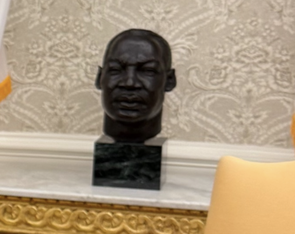 Bust of Martin Luther King Jr. On a cloak, with graceful wall and partial view of a chair in the background