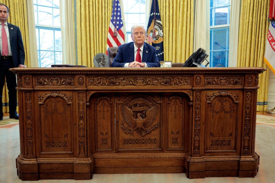 Donald Trump, Pictyured sitting at the Resolute Desk last month, announced that the Oval Office has a temporary make -over (Getty Images)