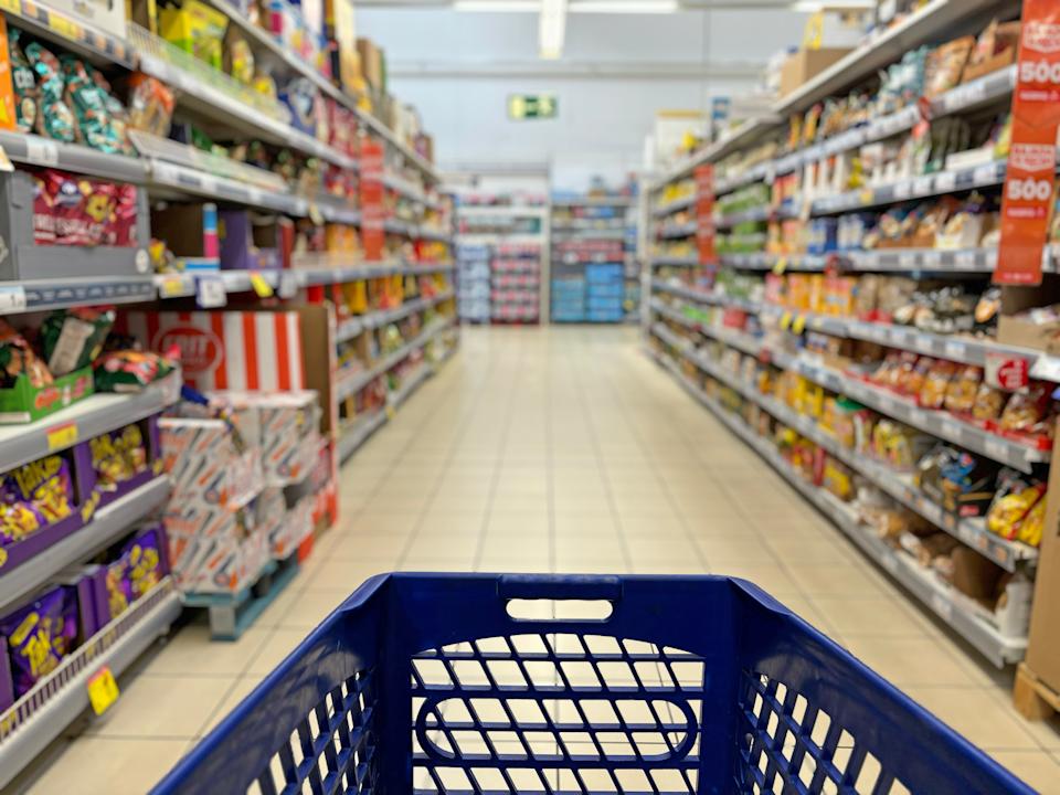 An empty trolley at supermarket corridor