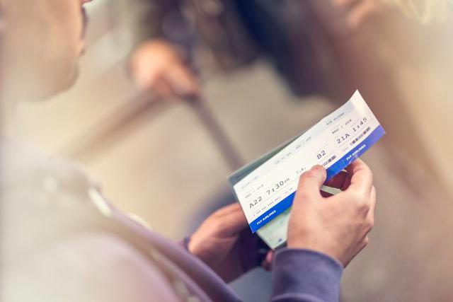 VM / Getty images A man with a plane ticket (stock image)