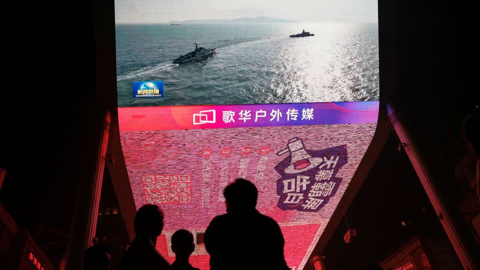 A screen in Beijing shows news images of military exercises led by the Chinese people liberation army around Taiwan on October 14, 2024. - Tingshu Wang/Reuters