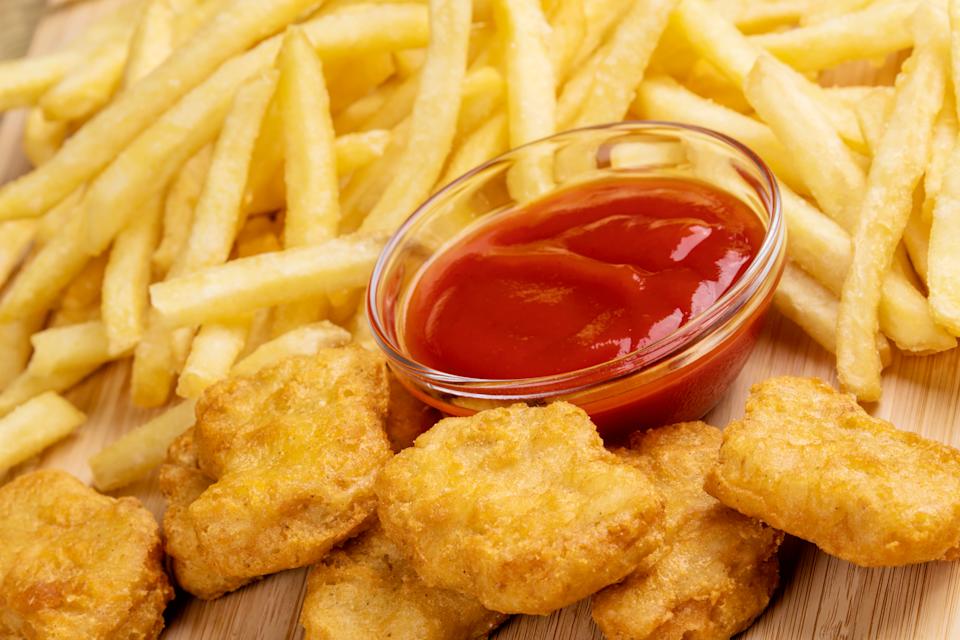 Chicken nuggets, fries and ketchup are sitting on a dish. According to a study, Canadians consume too many ultra -processed foods. (Photo via getty images)