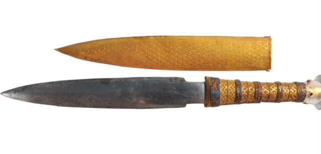 King Tutankhamun's iron dagger with its golden scabbard.  The full length of the dagger is 13.5 inches (34.2 cm).