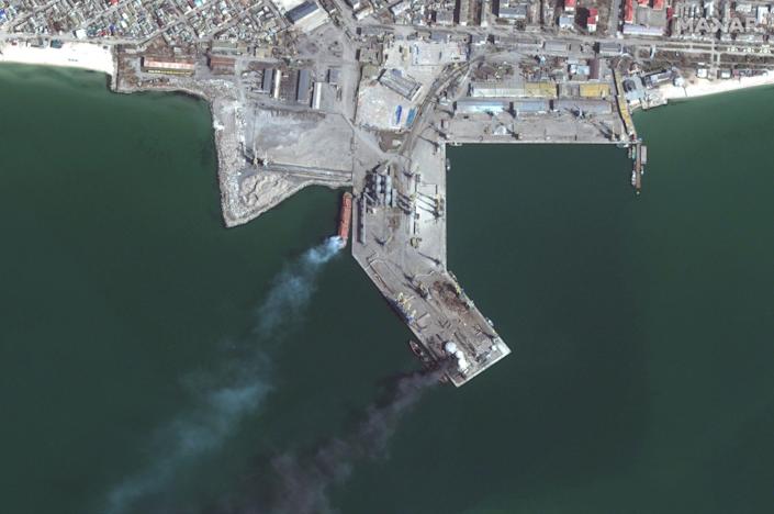 Satellite images show a Russian amphibious warship on fire in the port of Berdyansk (below) after it was struck by Ukrainian forces on match 24.