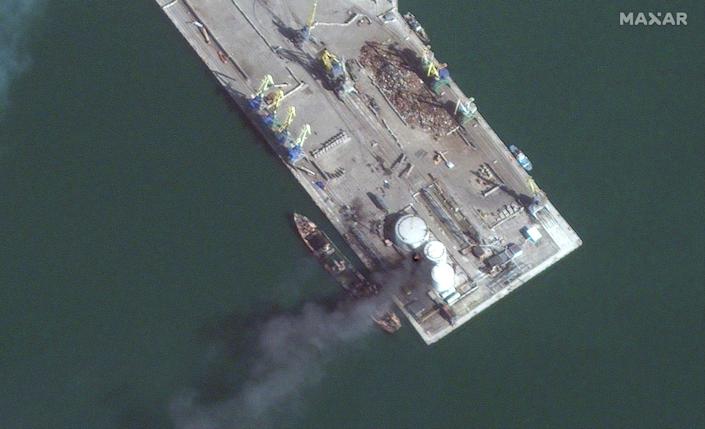 Satellite images show a Russian amphibious warship on fire in Berdyansk harbor after it was struck by Ukrainian forces on Match 24.