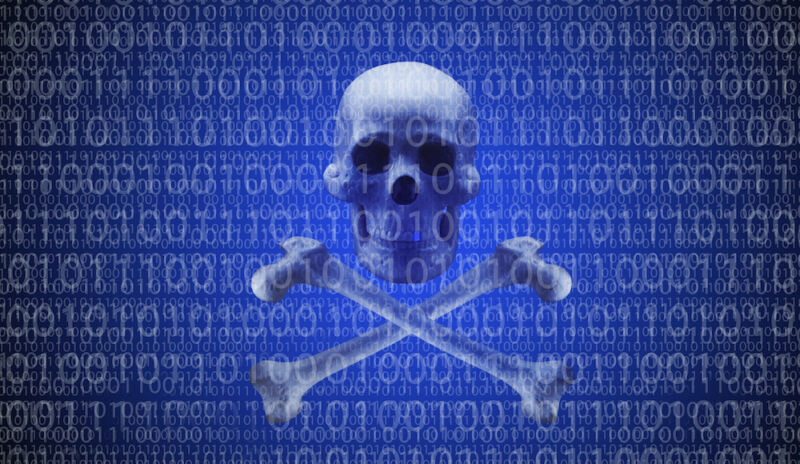 A skull and crossbones on a computer screen are surrounded by ones and zeros.