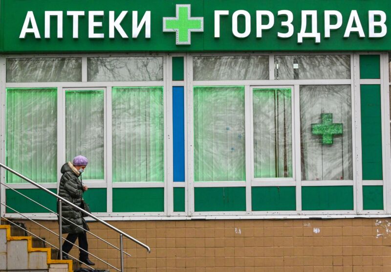 A woman wearing a face mask leaves a pharmacy in the city of Podolsk, about 40 kilometers outside Moscow, on November 12, 2021. 