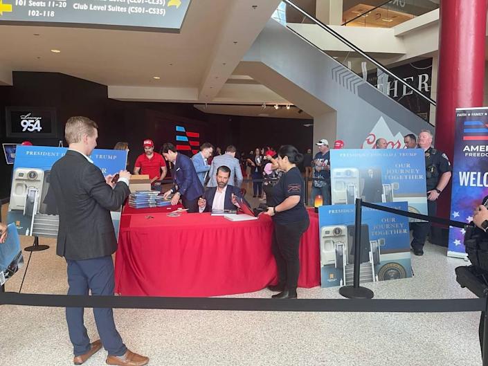 Donald Trump Jr.  signs copies of his father's book 'Our Journey Together'.