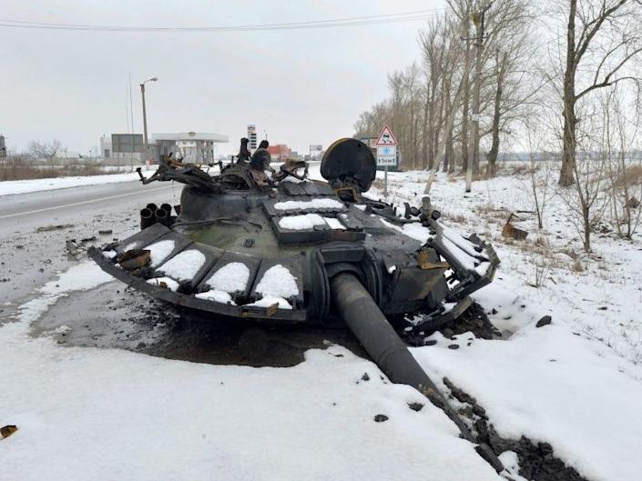 A fragment of a destroyed Russian tank can be seen along the road on the outskirts of Kharkov on February 26, 2022.