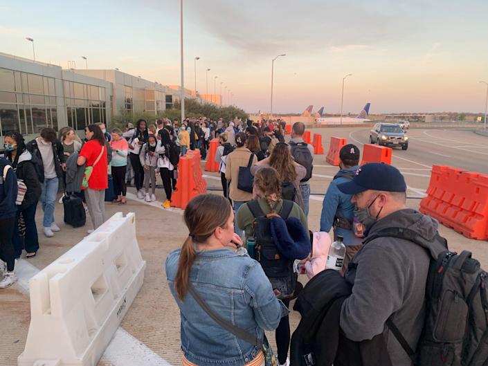 The security line at Austin-Bergstrom International Airport extends outside the building on Sunday morning.  Some travelers queued for hours, missed flights and even had to make alternate arrangements on weekends as the airport was unable to handle an unusually high passenger traffic caused in part by several high-profile sporting events.