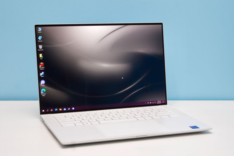 White version of the Dell XPS 15 9510 laptop standing open on a desk.