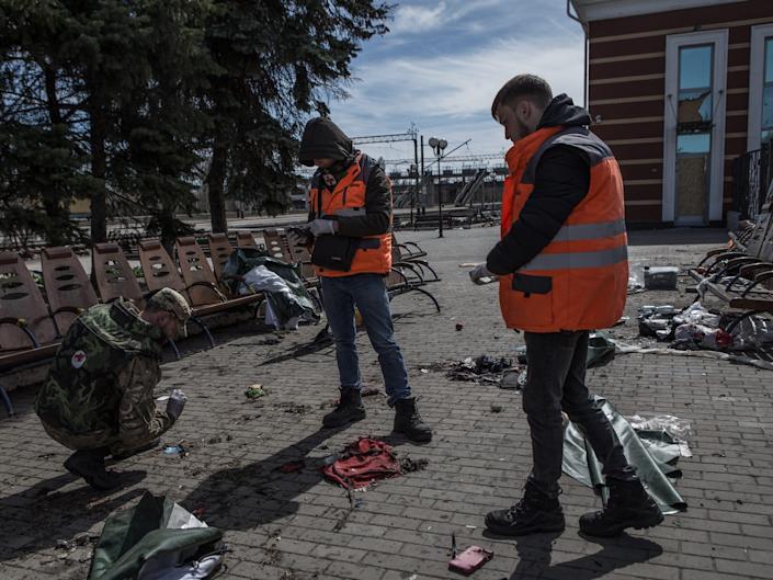 Some volunteers search for traces to help identify the corpses at Kramatorsk train station after the missile strike in Ukraine's Kramatorsk.