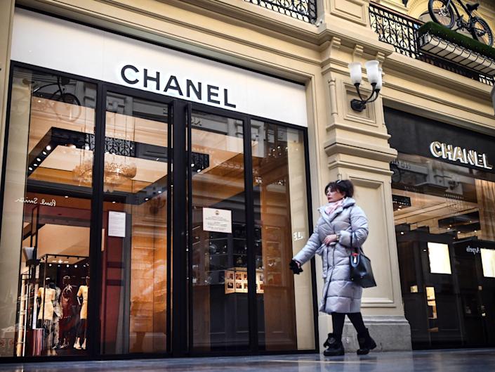 A woman walks past a closed Chanel store in Moscow on March 10, 2022