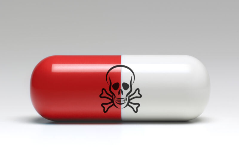 A pill with a skull and crossbones printed on it in an image of a poison pill.