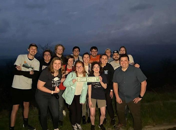 Gavin Short, Orange Shirt, and Nicholas Nair, to Short's left, are pictured with their friends.  Short and Nair were killed in a fatal car accident while returning home from a storm chase in Kansas.