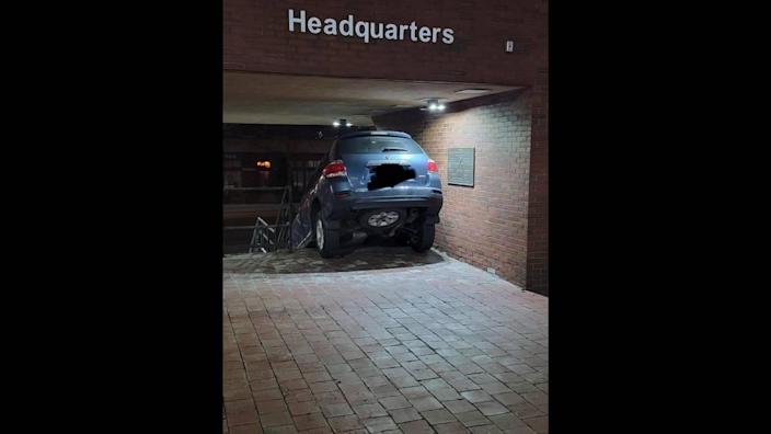 Officials posted photos showing the woman's SUV stuck on the steps of the police station.