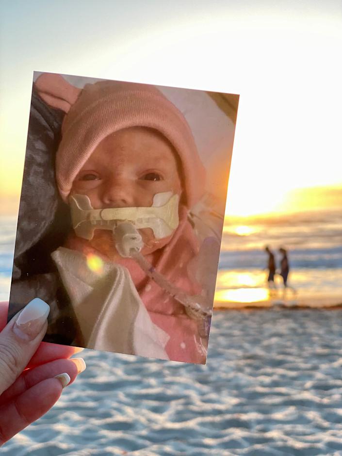 Cathy Soteropoulos holds a photo of her daughter Nola on April 26 at Canova Beach Park near Indian Harbor Beach.