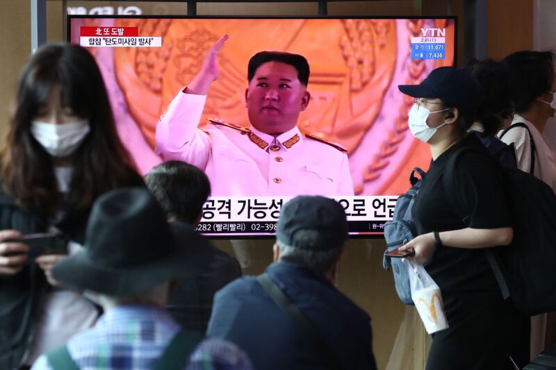 People watch a television broadcast featuring a file image of North Korean leader Kim Jong Un during a military parade at the Seoul Railway Station on May 4, 2022 in Seoul, South Korea.