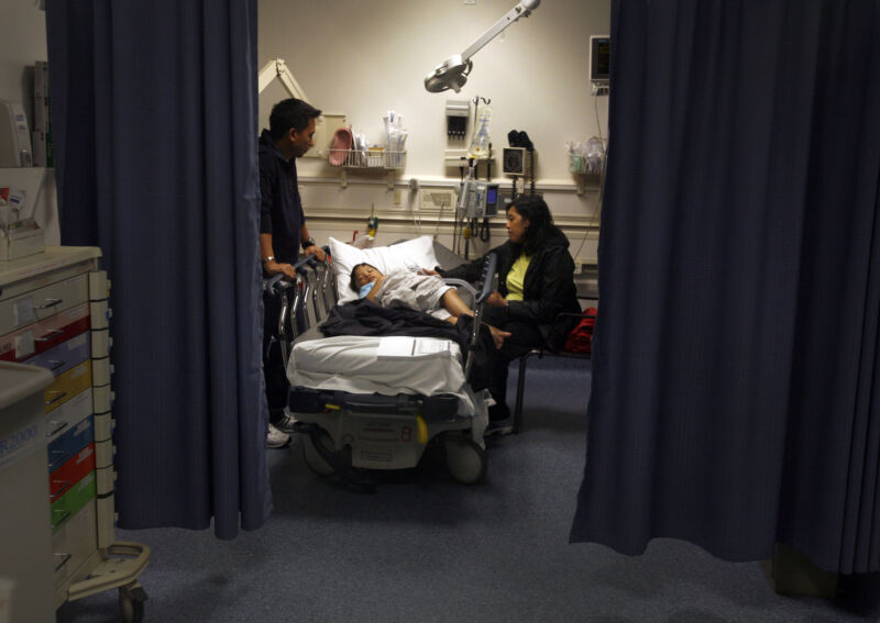 Parents care for their 5-year-old son being treated for croup and asthma in an emergency room at a California hospital on March 24, 2010.