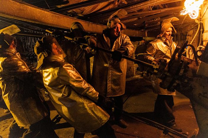 Steelworkers wear fireproof clothing while servicing the blast furnace at the ArcelorMittal steel plant in Ukraine's Kryvyi Rih, May 5, 2022. (David Guttenfelder/The New York Times)