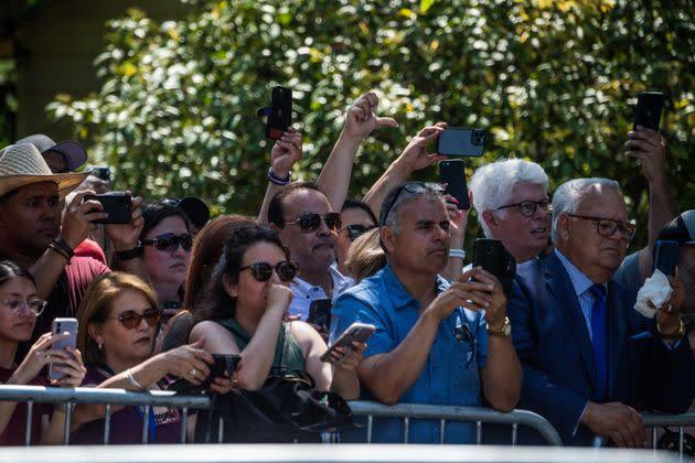 Fenced crowd cheers and thumbs up at Texas GOP Governor Greg Abbott as he arrives as President Joe Biden and First Lady Jill Biden pay their respects at a makeshift memorial outside Robb Elementary School in Uvalde.  (Photo: CHANDA KHANNA via Getty Images)