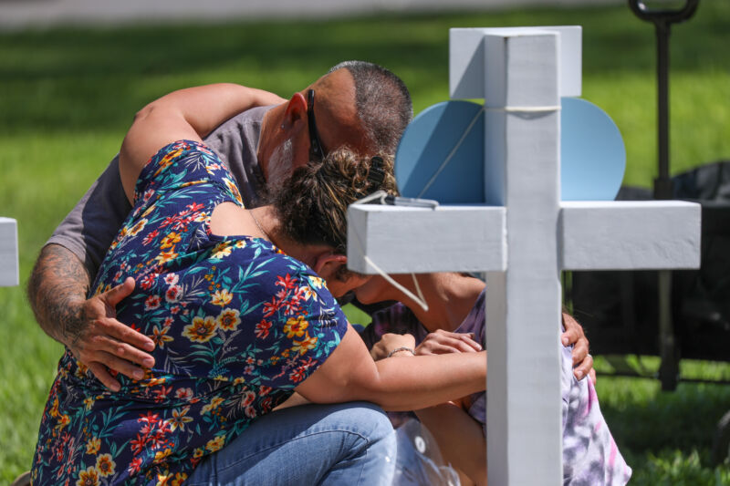 Mourners visit a memorial to the victims of Tuesday's mass shooting at an elementary school in Uvalde, Texas. 