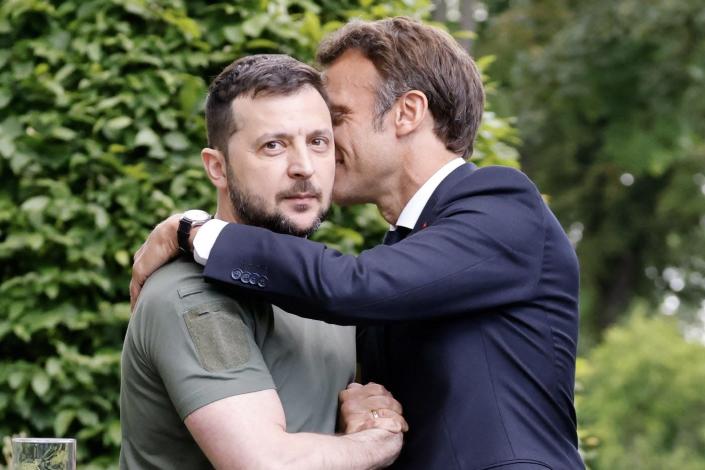 Ukrainian President Volodymyr Zelenskyy, left, shakes hands with French President Emmanuel Macron after a press conference in Kiev, Thursday, June 16, 2022.