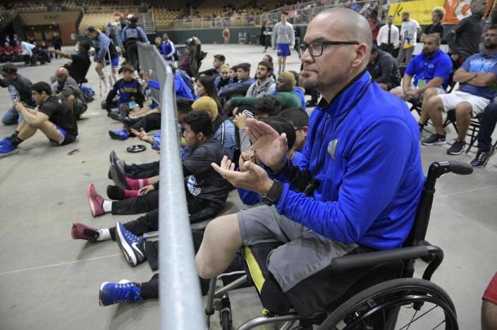 South Dade Director Javier Perez watches one of the school's championship matches during the FHSAA State Wrestling Finals, Saturday, March 4, 2017 in Kissimmee, Florida.