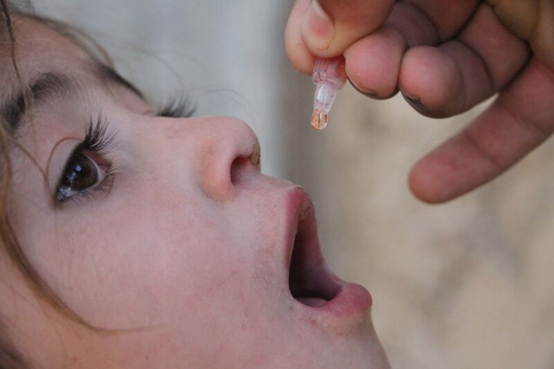 A health worker administers a polio vaccine to a child from Kabul, Afghanistan, on May 17, 2016. 