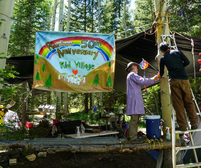 Members of the Kid Village camp at the Rainbow Family gathering have set up a shadow over their group kitchen in preparation for the annual camp in Routt National Forest on June 26.