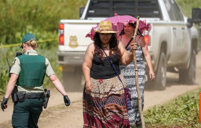 US Forest Service police officers walk through a parking lot at the Rainbow Family gathering on June 26.