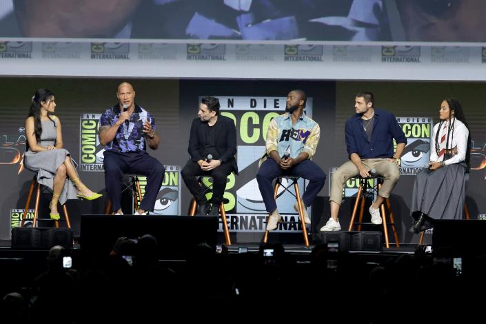 From left to right: Tiffany Smith, Dwayne Johnson, Jaume Collet-Serra, Aldis Hodge, Noah Centineo and Quintessa Swindell on the stage of the Warner Bros. panel promoting "Black Adam"  at San Diego Comic Con.